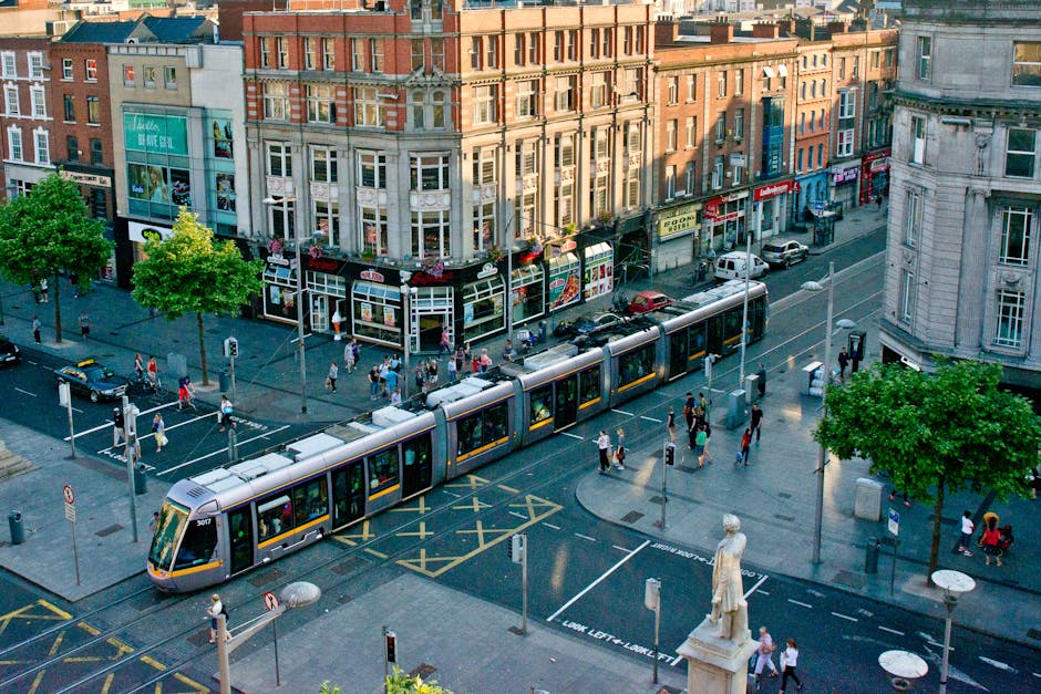Vibrant scene of Dublin city center showcasing tram and bustling streets from above.