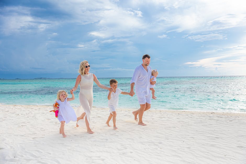 Family enjoying a walk on a pristine beach with turquoise waters, captured in a light-hearted moment.